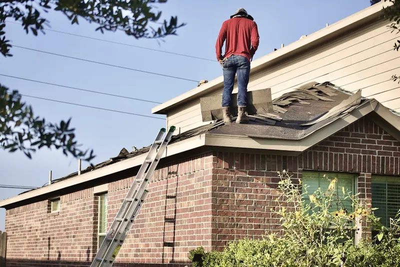 Professional roofer working on a residential roof in White Rock Acres